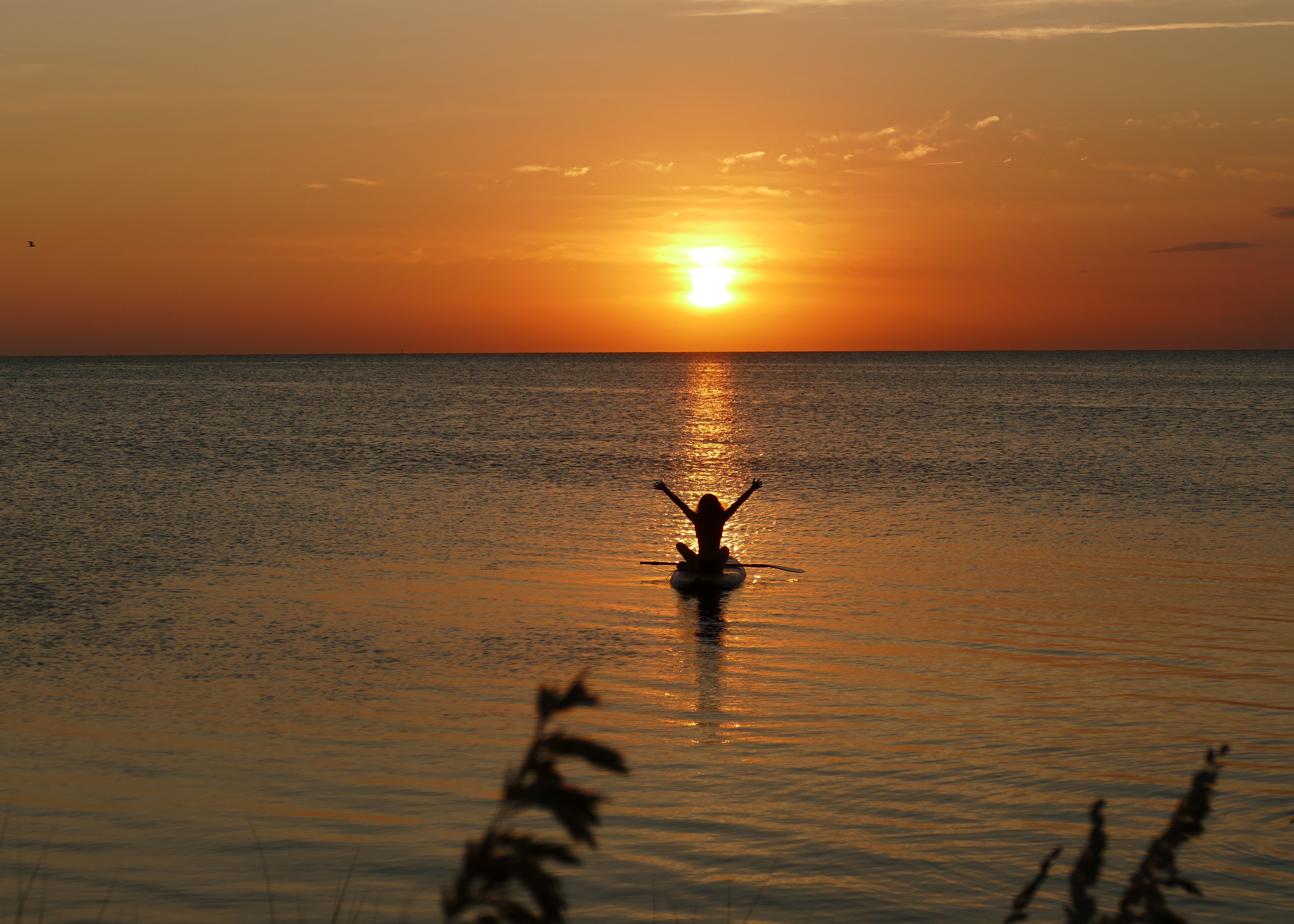 Paddleboarder at sunset on Pamlico Sound Hatteras Island