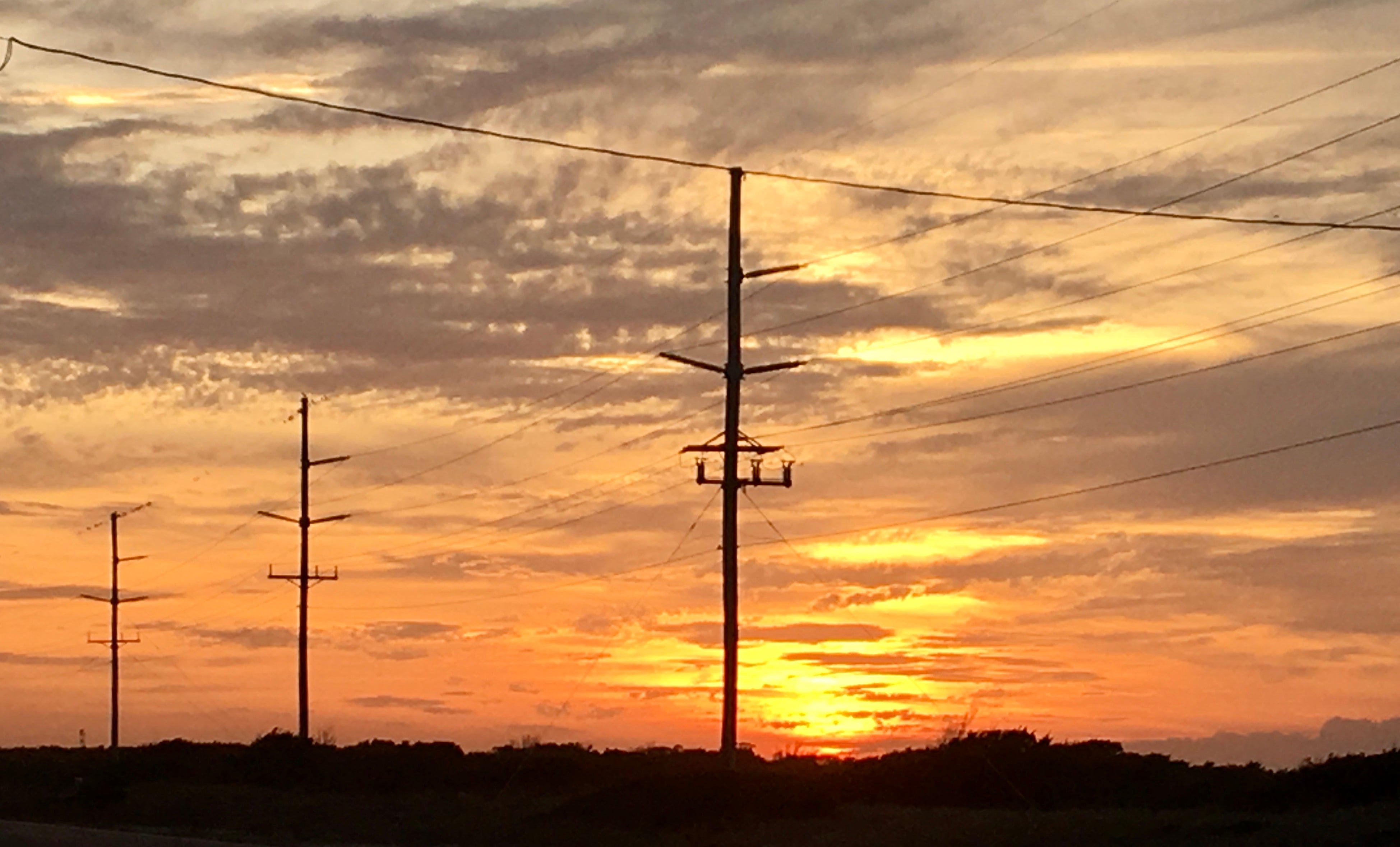 Power lines with sunset in the background Cape Hatteras
