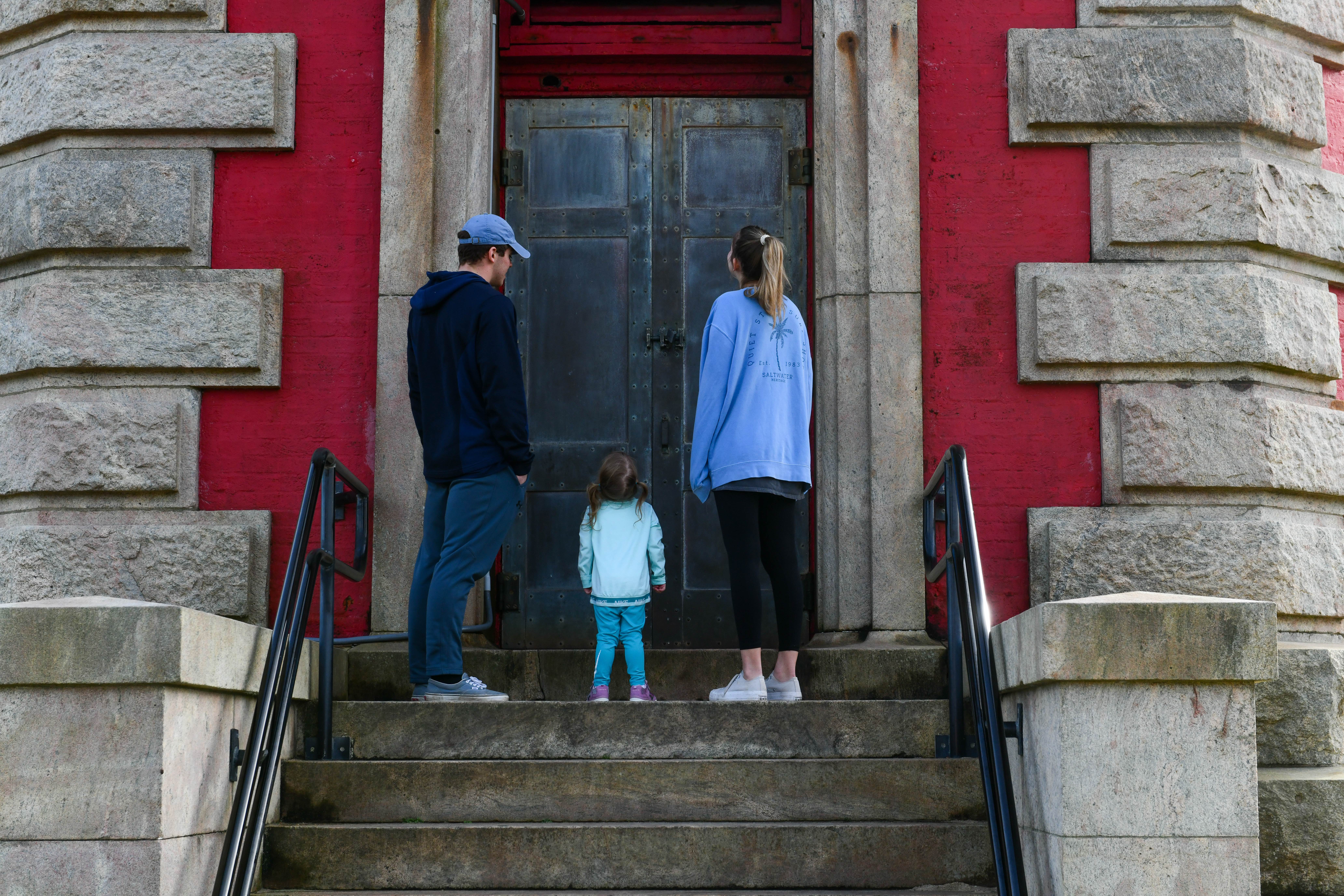 Family strains gby door of Cape Hatteras lighthouse Buxton NC