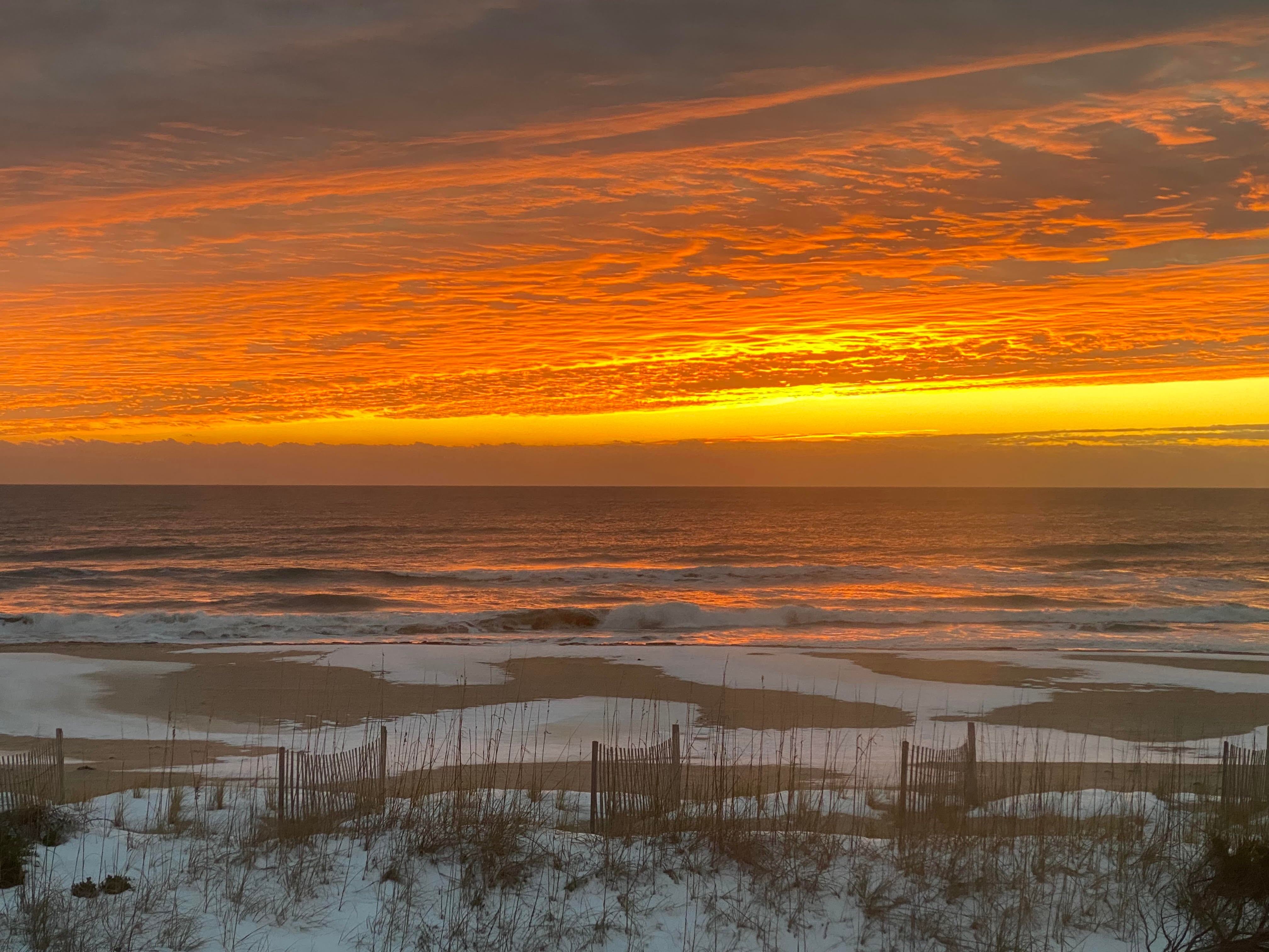 Cape Hatteras National Seashore beach at sunrise with snow on the sand