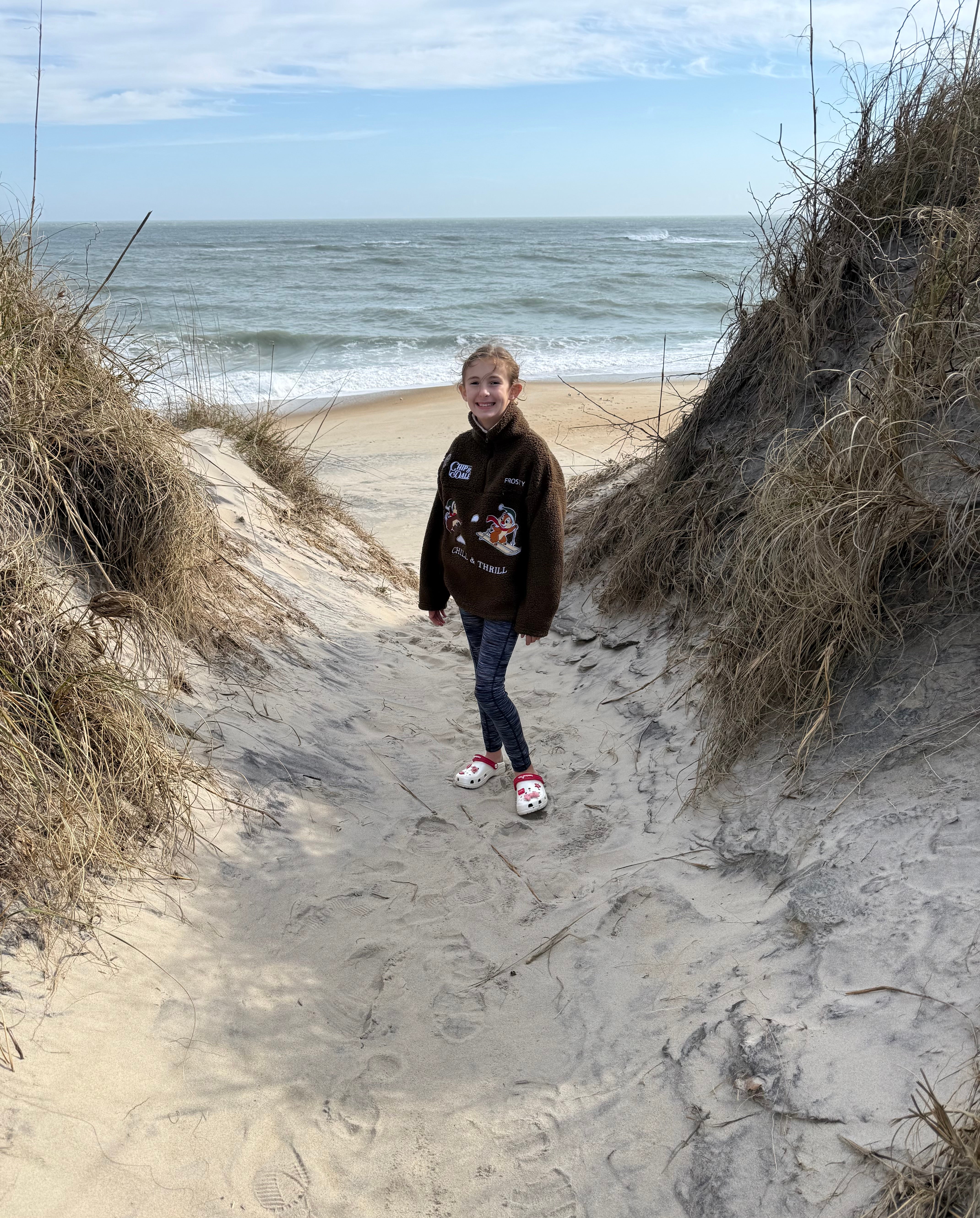 Young girl stands in the Dunes at Cape Hatteras National Seashore