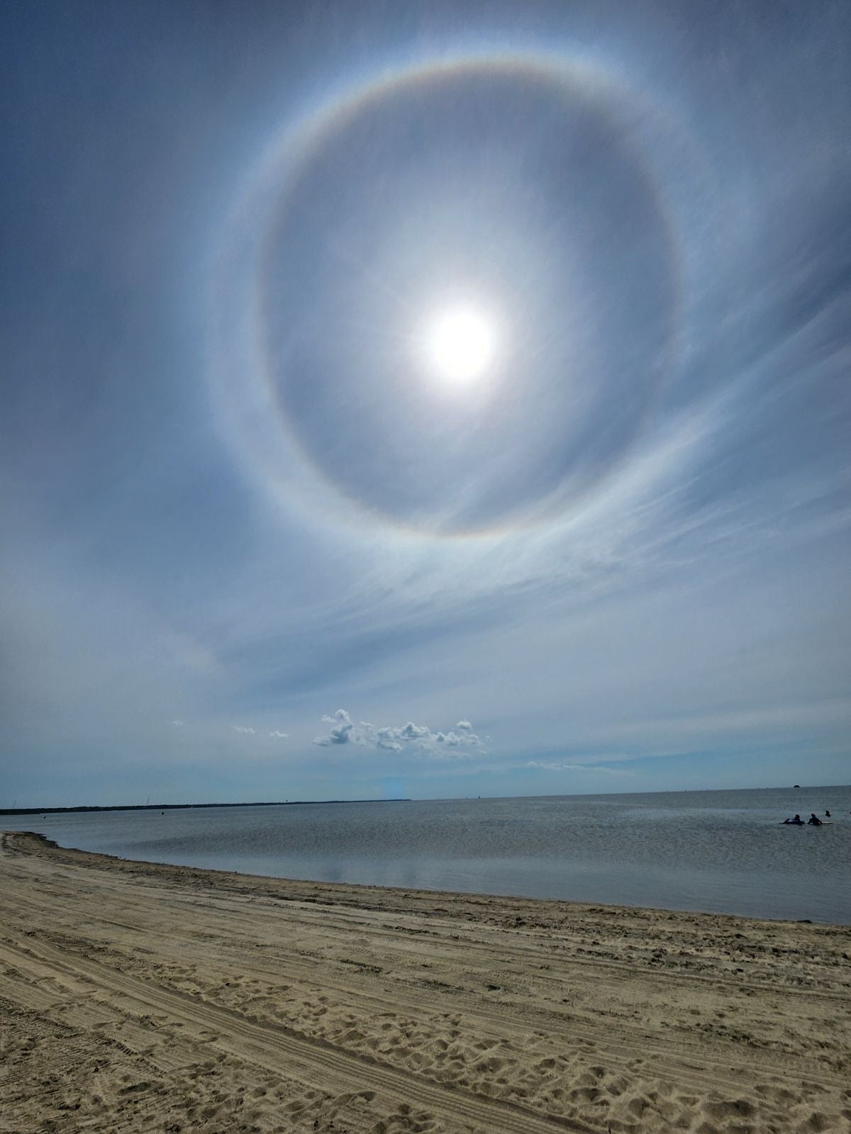 Sun in a blue sky with a glowing halo around it