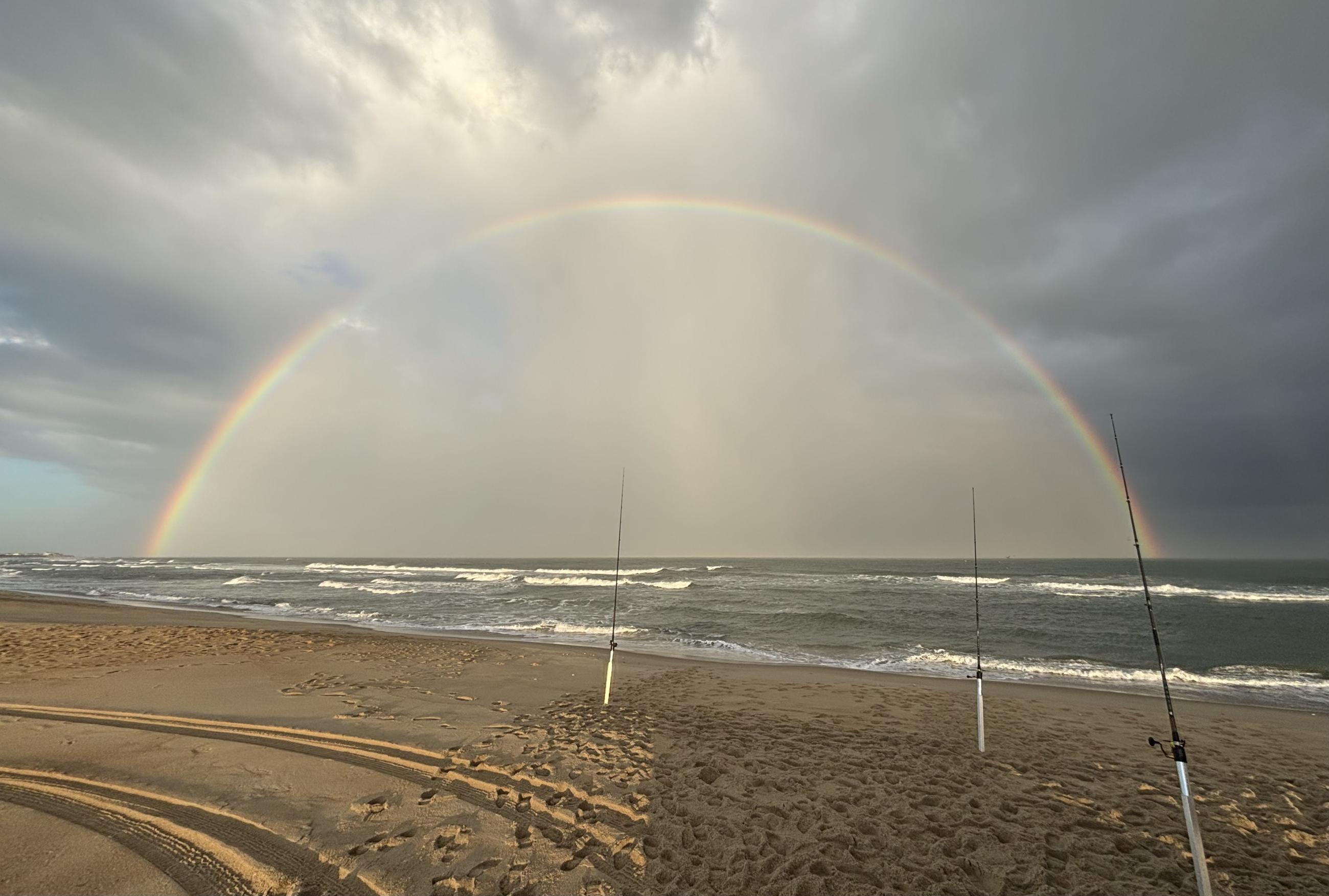 Rainbow over the ocean and fishing rods at Cape Hatteras National Seashore