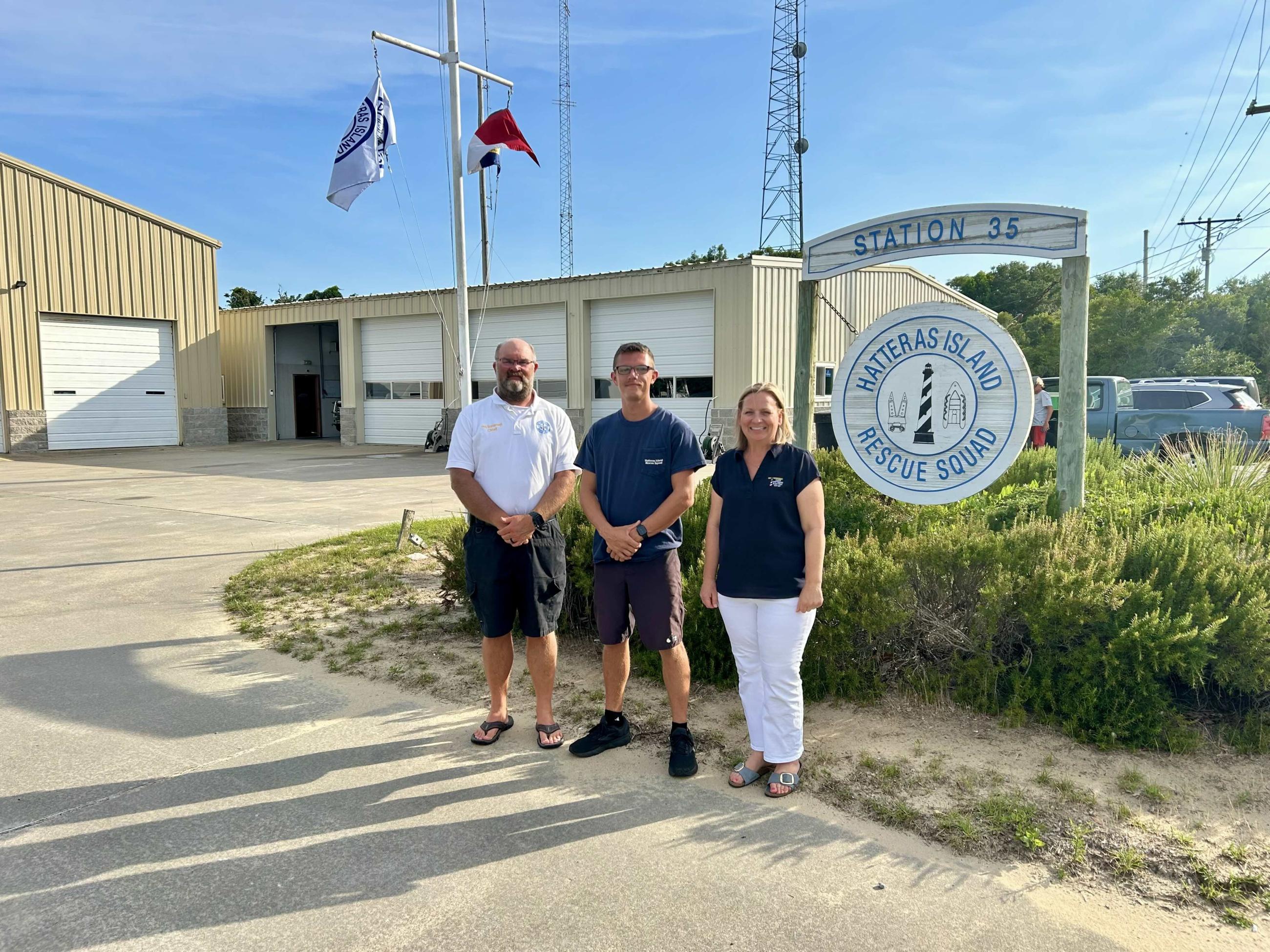 Representatives from Hatteras Island Rescue Squad stand at the station with CHEC's Stephanie Snead