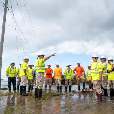 CHEC Linemen on jobsite in flooded beach 