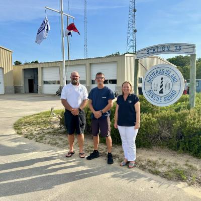 Representatives from Hatteras Island Rescue Squad stand at the station with CHEC's Stephanie Snead